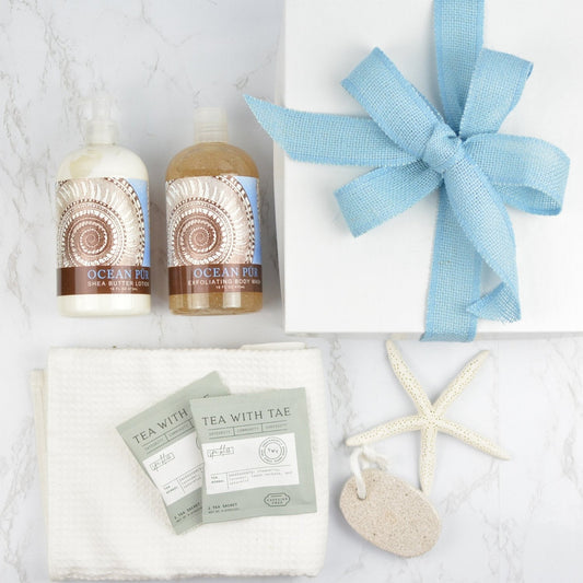 Beach Relaxation Gift Box with ocean-inspired spa products, calming teas, pumice stone, and blue ribbon gift box
