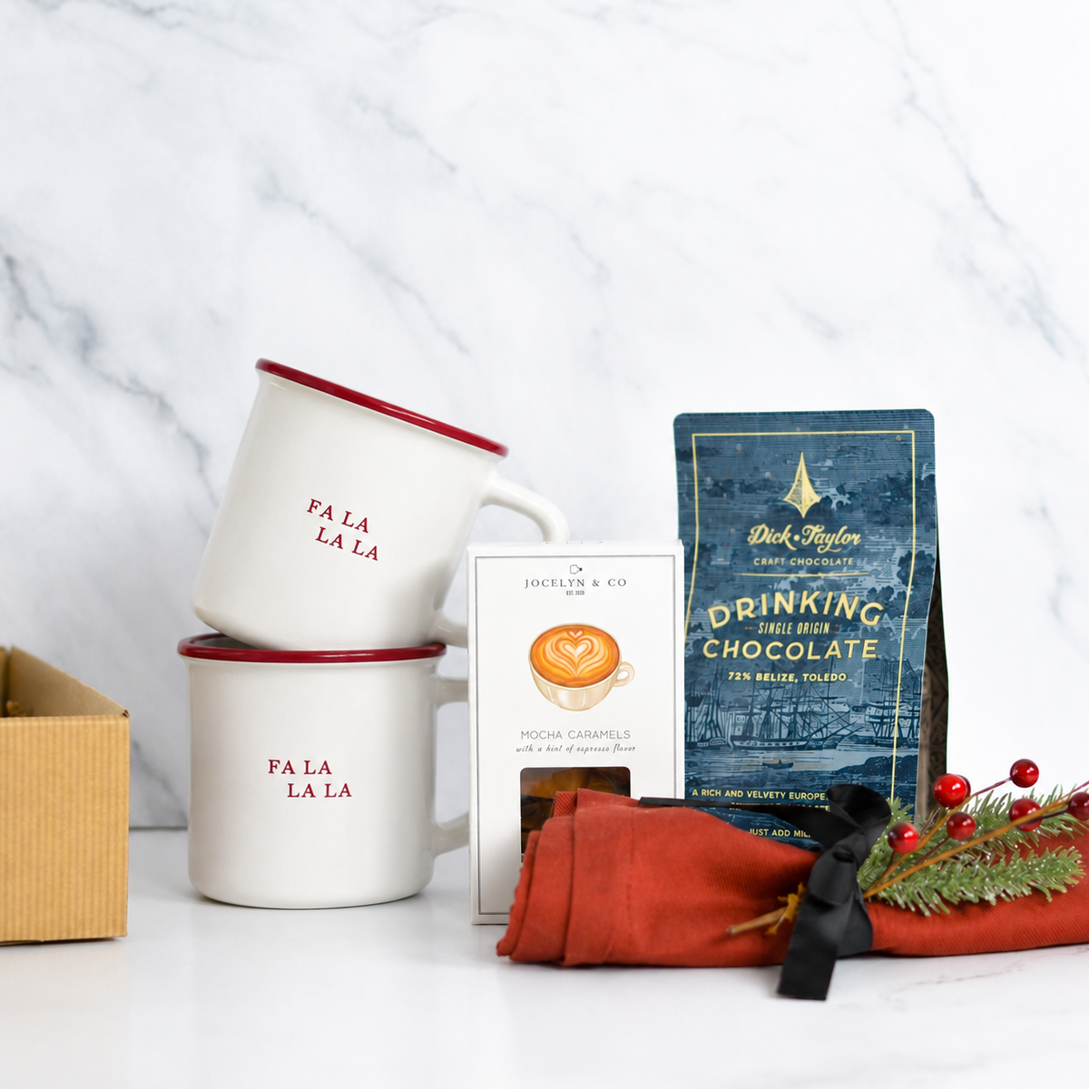 gift basket with 2 mugs that say fa la la la mocha caramels, towel and dick taylor drinking chocolate