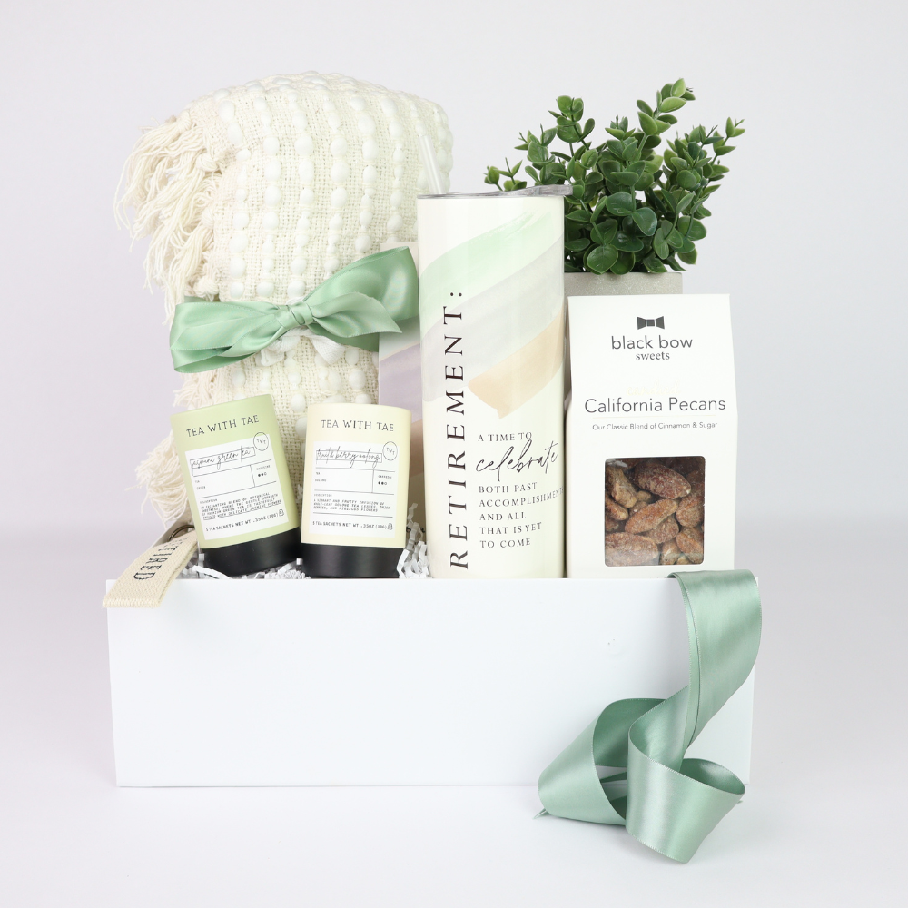 retirement gift box for her ith tea, blankets, nuts and tumbler